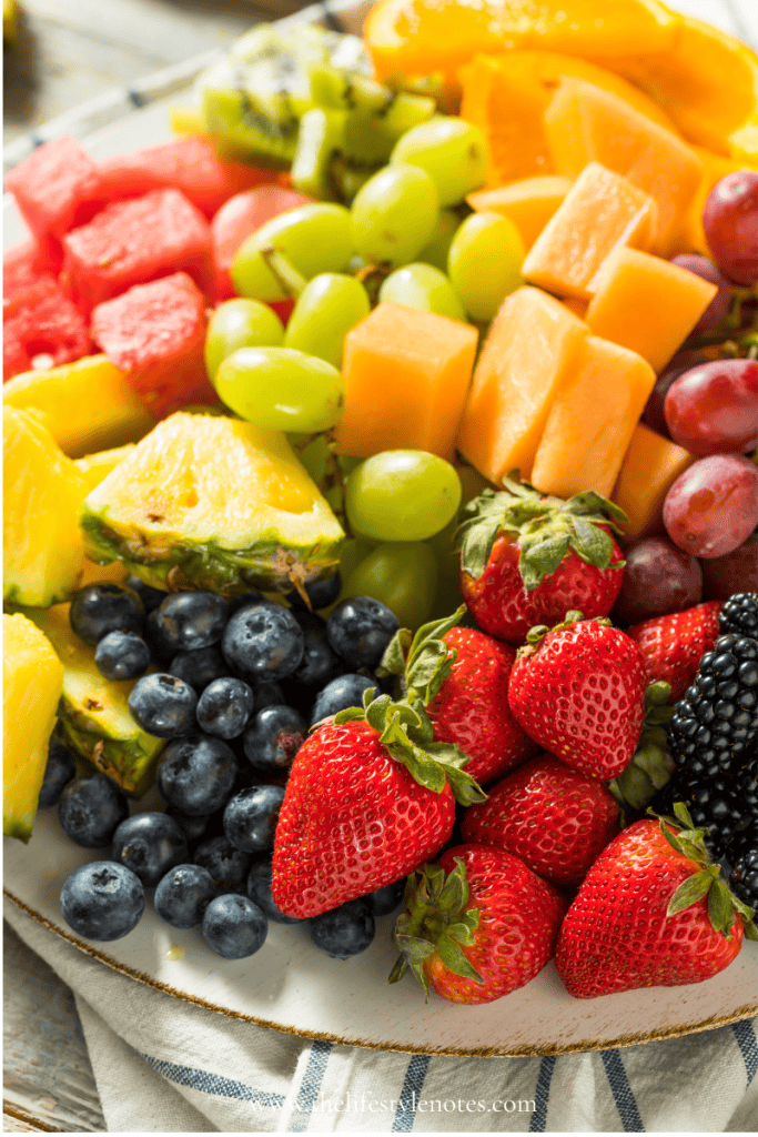 Easy Gluten Free Desserts for Summer. Platter of cut melon, grapes, pineapple, strawberries, raspberries, and blackberries.