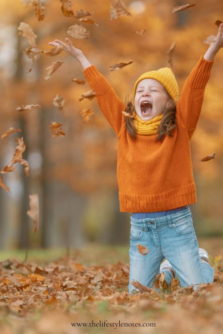 Simple Ways for Families to Boost Immunity and Stay Healthy This Fall. Little girl playing in fall leaves.